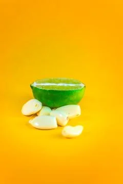Graphic close up of a slice of lemon surrounded by garlic cloves over a backg Stock Photos