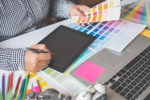The graphic designer creative team is currently working on the design and col Stock Photos