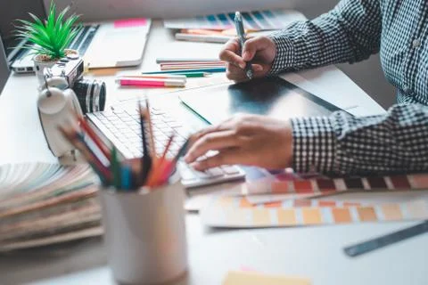 The graphic designer creative team is currently working on the design and col Stock Photos
