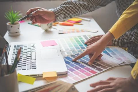 The graphic designer creative team is currently working on the design and col Stock Photos