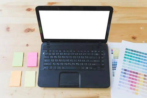 Graphic designer desk table with computer, sticky note and color guide pale.. Stock-Fotos