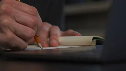 A graphic designer draws a prototype of an icon visual with a pencil on paper Stock Footage 172527370