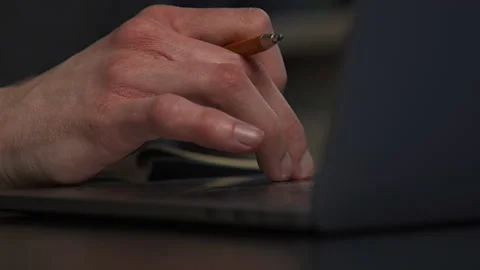A graphic designer draws a prototype of an icon visual with a pencil on paper Stock Footage 172527446