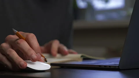 A graphic designer draws a prototype of an icon visual with a pencil on paper Stock Footage 172527556