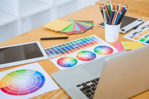 Graphic designer object tool and color swatch samples at workspace Stock Photos