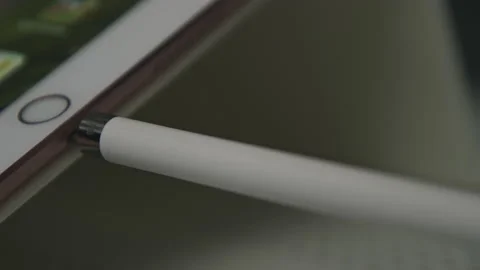 Graphic designer pulling stylus from tablet to draw icon design prototypes Stock Footage 172527256