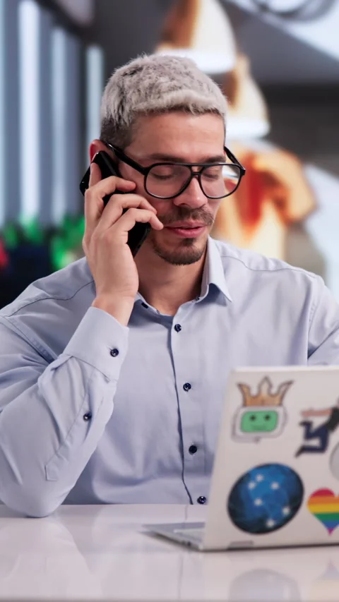 Graphic Designer Talking On Phone With Client While Creating Web Art Stock Footage 333399316