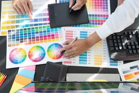 Graphic designer team working on web design using color swatches editing ar.. Stock Photos