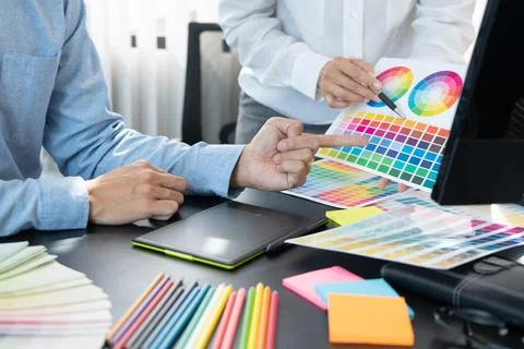 Graphic designer team working on web design using color swatches editing ar.. Stock Photos