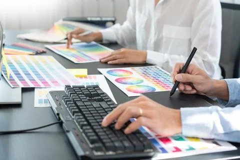 Graphic designer team working on web design using color swatches editing ar.. Stock Photos