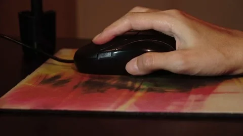 A graphic designer uses a mouse and computer in a dark studio. Stock Footage 196685841
