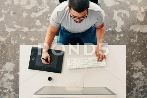Graphic designer using digital graphics tablet and desktop Stock Photos