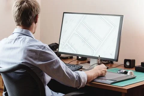 Graphic designer using digital tablet and computer in office or Stock Photos