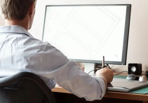 Graphic designer using digital tablet and computer in office or Stock Photos