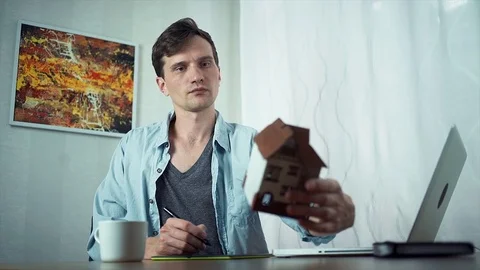 Graphic designer using graphic tablet creating housing project on laptop Stock Footage 79902663