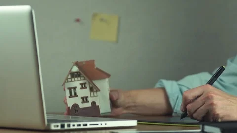 Graphic designer using graphic tablet creating housing project on laptop Stock-Footage 81880439