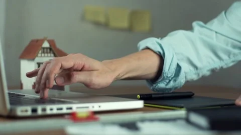 Graphic designer using graphic tablet creating housing project on laptop Stock Footage 81880771