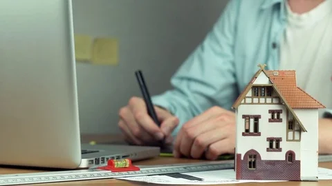 Graphic designer using graphic tablet creating housing project on laptop Stock Footage 81881444