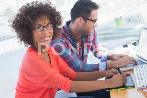 Graphic designer using a graphics tablet in her office Stock Photos