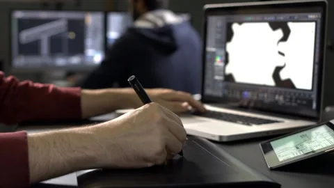 Graphic designer using laptop and digital pen Stock Footage 200708934