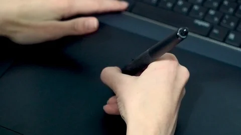 Graphic designer at work. The designer draws a graphic pen on the tablet Stock Footage 122643509
