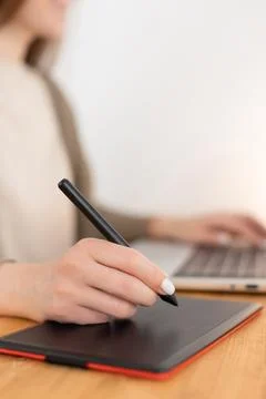 Graphic designer work with digital tablet and laptop. Wooden workspace. Woman Stock Photos