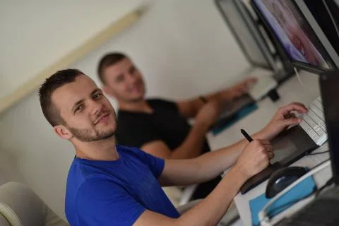 Graphic designer at work Young graphic designer working on a digital table... Stock Photos