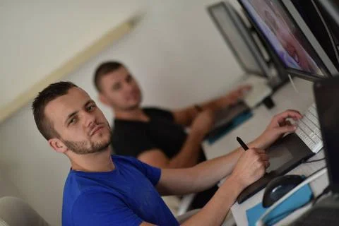 Graphic designer at work Young graphic designer working on a digital table... Stock Photos