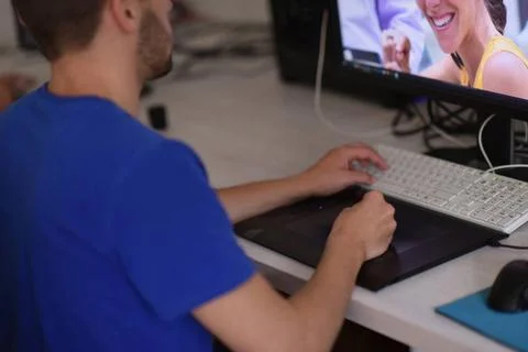 Graphic designer at work Young graphic designer working on a digital table... Stock Photos