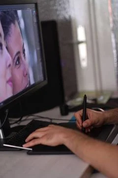 Graphic designer at work Young graphic designer working on a digital table... Stock Photos