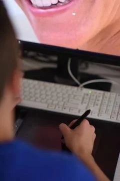 Graphic designer at work Young graphic designer working on a digital table... Stock Photos