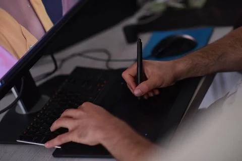 Graphic designer at work Young graphic designer working on a digital table... Stock Photos