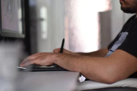 Graphic designer at work Young graphic designer working on a digital table... Stock Photos