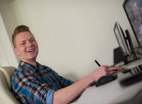 Graphic designer at work Young graphic designer working on a digital table... Stock Photos