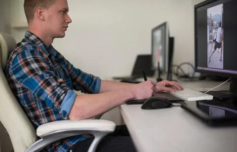 Graphic designer at work Young graphic designer working on a digital table... Stock Photos