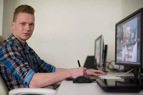 Graphic designer at work Young graphic designer working on a digital table... Stock Photos