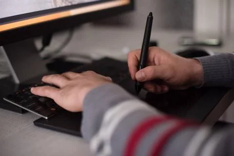 Graphic designer at work Young graphic designer working on a digital table... Stock Photos