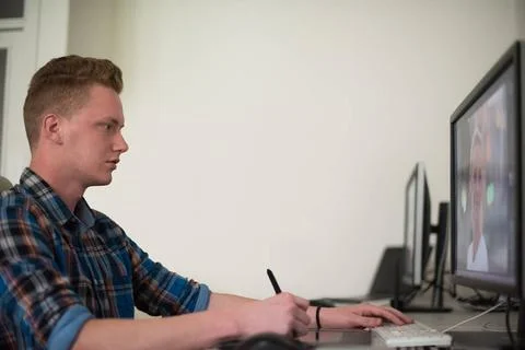 Graphic designer at work Young graphic designer working on a digital table... Stock Photos