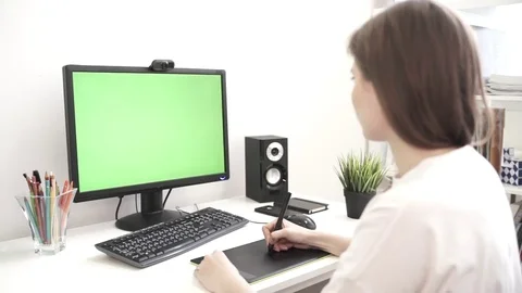 Graphic designer working on computer using tablet Stock Footage 76196014