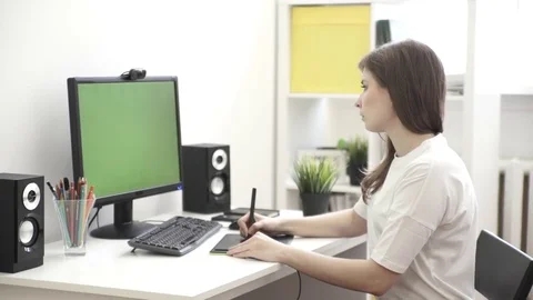 Graphic designer working on computer using tablet Stock Footage 76196110