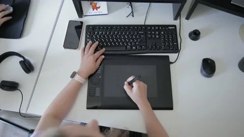 Graphic designer working on digitizer at her desk in creative office Stock Footage 144545458