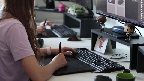 Graphic designer working on digitizer at her desk in creative office Stock Footage 144551765
