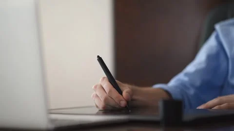 Graphic designer working on a drawing tablet, creating digital art and illu.. Stock Footage 339373458