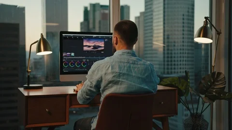 Graphic designer working from home on computer, view of Downtown LA Stock Footage 127402201