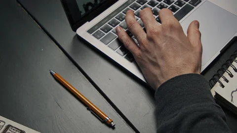 Graphic designer working late at night on icon project behind laptop Stock Footage 172575355