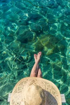 Graphic image of top down view of woman wearing big summer sun hat relaxing on Stock Photos