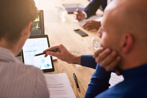 Graphic information being displayed on a tablet during business meeting Stock Photos