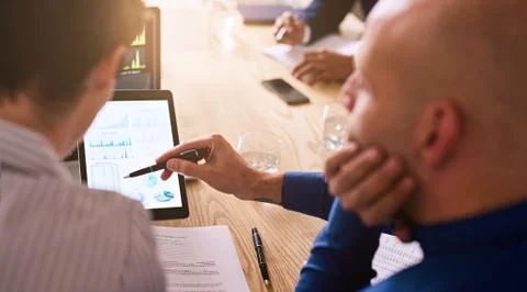 Graphic information being displayed on a tablet during business meeting Stock Photos