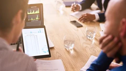 Graphic information being displayed on a tablet during business meeting Stock Photos