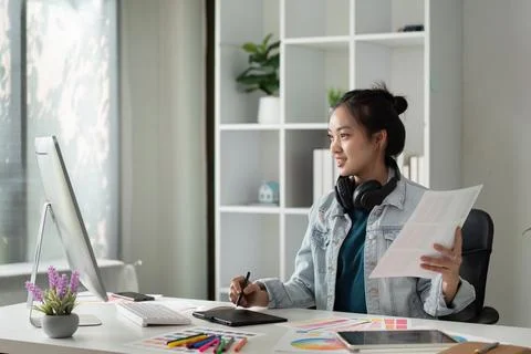 Graphic or UI designer work on computer laptop and with graphic drawing pen Stock Photos